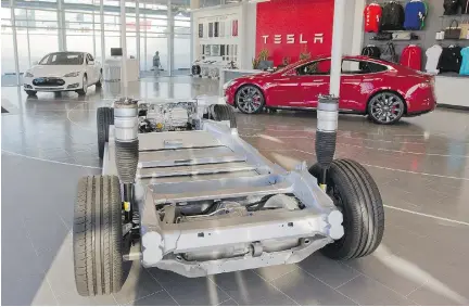  ?? JOHN KENNEY/MONTREAL GAZETTE FILES ?? A cutaway view of a Model S body sits in a showroom at the Tesla Motors dealership in Montreal. Provincial rebates for all-electric and plug-in vehicles are not convincing enough Quebecers to dive in, Peter Hadekel writes.