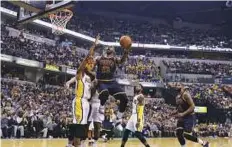  ?? AP ?? Cleveland Cavaliers’ LeBron James shoots against Indiana Pacers’ Thaddeus Young during the first half on Sunday.