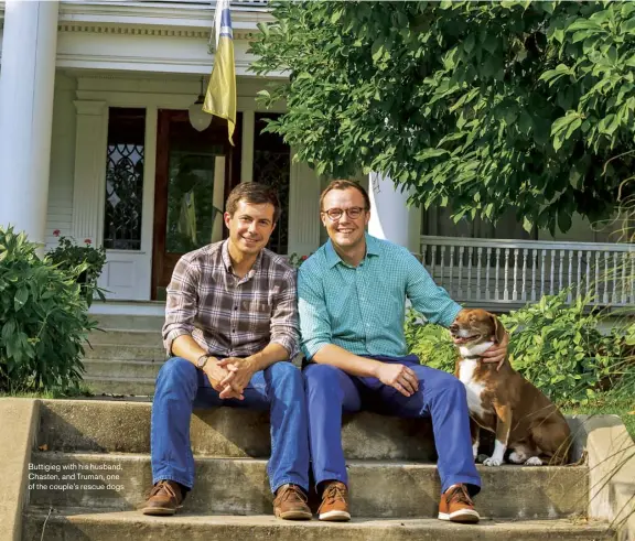  ??  ?? Buttigieg with his husband, Chasten, and Truman, one of the couple’s rescue dogs