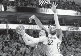  ?? MICHAEL AINSWORTH AP ?? The Mavericks’ Luka Doncic, who had 30 points, 17 rebounds and 10 assists, is fouled by the Pelicans’ Derrick Favors on his way to the basket.