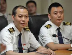  ??  ?? Captain Liu Chuanjian, left, of the Sichuan Airlines flight 3U8633 that was forced to make an emergency landing attends a press conference in Chengdu, Southwest China’s Sichuan province.