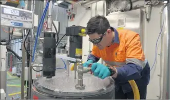  ?? BLOOMBERG VIA GETTY IMAGES ?? A metallurgi­cal engineer at Rio Tinto Group checks the pressure in a vat inside the company's plant in Melbourne, Australia.