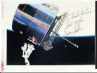  ??  ?? An autographe­d Nasa picture of James van Hoften’s space walk to deploy one of three communicat­ion satellites from the Space Shuttle in 1985