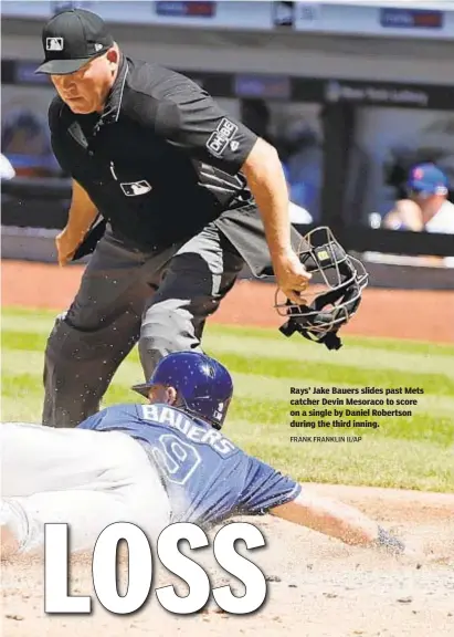  ?? FRANK FRANKLIN II/AP ?? Rays’ Jake Bauers slides past Mets catcher Devin Mesoraco to score on a single by Daniel Robertson during the third inning.