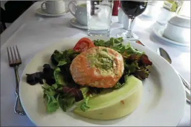  ?? JANET PODOLAK — THE NEWS-HERALD ?? A salmon dinner is artfully plate and paired with a glass of Okanagan wine. Both are from British Columbia.