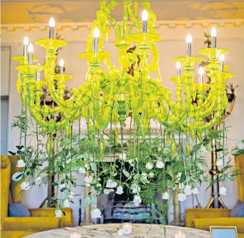  ??  ?? Natural charm: draping flowers from a candelabru­m, or in a doorway, can create a wild garden feel, says Rowan Lewis, inset