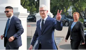  ?? AFP-Yonhap ?? Apple CEO Tim Cook gestures as he arrives for a meeting with Indonesia’s President Joko Widodo at the Merdeka Palace in Jakarta on Wednesday.