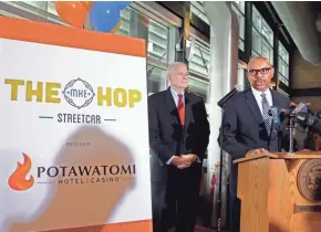  ?? JOURNAL SENTINEL RICK WOOD / MILWAUKEE ?? Milwaukee Mayor Tom Barrett watches Rodney Ferguson, Potawatomi’s chief executive officer and general manager, respond after Barrett announces the Milwaukee streetcar has a corporate sponsor and will offer free rides for its first year of operation.