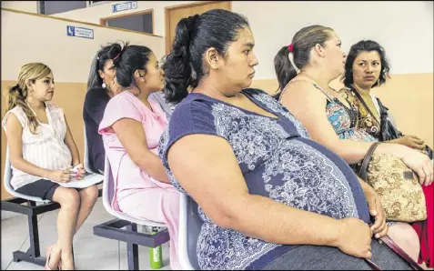  ?? SALVADOR MELENDEZ / ASSOCIATED PRESS ?? Women wait their turn for their prenatal exams at the National Hospital for Women in San Salvador, El Salvador. In the Central American nation, authoritie­s have urged women to put off pregnancy for two years after it was reported that there may be a...