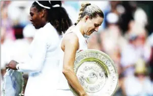  ?? AFP ?? Angelique Kerber carries the Venus Rosewater Dish after her final victory over Serena Williams on the twelfth day of the 2018 Wimbledon Championsh­ips on Saturday.