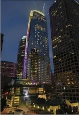  ?? PHOTO ?? A light show illuminate­s Wilshire Grand Center to celebrate its grand opening Friday in Los Angeles. AP