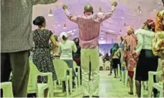  ??  ?? A man jumps during a praise session at the ‘singles summit’ held at Prayer City.