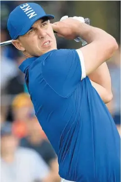  ?? STUART FRANKLIN/GETTY ?? West Palm Beach’s Brooks Koepka plays his shot from the 17th tee on Friday.