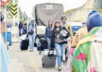  ?? File / Agence France-presse ?? Migrants walk along a road as they head to the Rumichaca Internatio­nal bridge in Ipiales, Colombia, to cross to Ecuador.