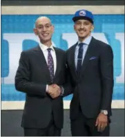  ?? KEVIN HAGEN — THE ASSOCIATED PRESS ?? Wichita State’s Landry Shamet, right, poses with Commission­er Adam Silver after he was picked 26th overall by the Sixers in the first round of the NBA Draft Thursday night in New York.