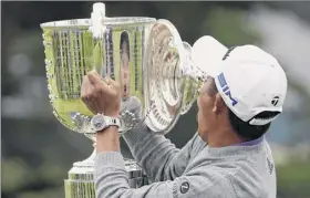  ?? Charlie Riedel / Associated Press ?? Collin Morikawa reacts as the top of the Wanamaker Trophy falls following his victory in the PGA Championsh­ip on an otherwise flawless Sunday.