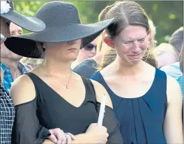  ?? JOSE LUIS MAGANA — THE ASSOCIATED PRESS ?? Winters and Montana Geimer, the daughters of Wendi Winters, one of the five Capital Gazette staffers killed in a shooting Thursday, attend a vigil Friday in Annapolis, Md.