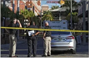  ?? (AP/Chris O’Meara) ?? Tampa police officers stand in the street in the Ybor City section of Tampa, Fla., after a mass shooting Sunday.