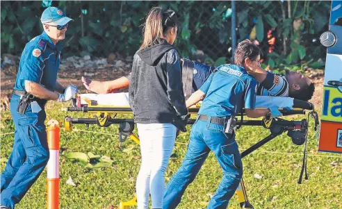  ?? Picture: JUSTIN BRIERTY ?? RUSHED TO HOSPITAL: Ambulance officers attend to injured Brothers player Ben Joseph during the Southside Crusaders and Brothers match at West Barlow Park.