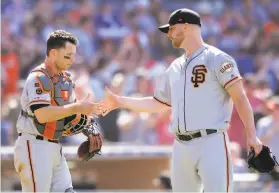  ?? Orlando Ramirez / Associated Press ?? 2019: Buster Posey (left) shakes hands with reliever Will Smith after Sunday’s win in San Diego. Smith is thought to be among the Giants mostly likely to be traded.