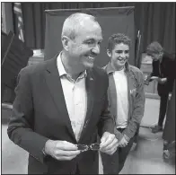  ?? AP/The Daily Record/BOB KARP ?? New Jersey gubernator­ial winner
Phil Murphy leaves his polling place with his son Sam after voting Tuesday at the Fairview School in Middletown.