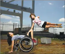  ?? DAVID DE SILVA — AXIS DANCE COMPANY ?? Axis Dance Company members Carina Ho, left, and Lani Dickinson rehearse near the Oakland waterfront. The company performs its fall season Oct. 26-29in Oakland.