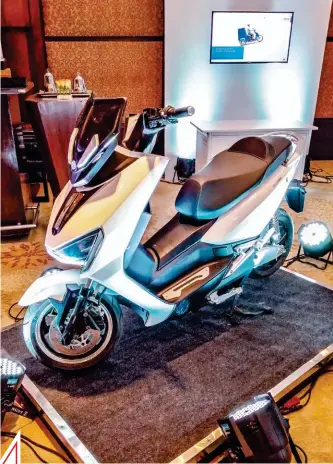  ??  ?? ABOVE: Prototype e-scooter shows connectivi­ty tech, compact battery pack, in-hub drive motor, among other solutions