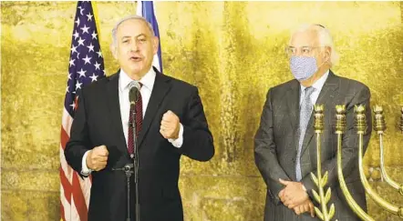  ?? EMIL SALMAN AP ?? Israeli Prime Minister Benjamin Netanyahu (left) and U.S. Ambassador to Israel David Friedman address the media on the first night of Hanukkah in Jerusalem on Thursday. Israel and Morocco have agreed to normalize ties in a U.S.-brokered deal.