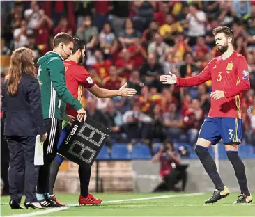  ??  ?? Your turn: Spain’s Gerard Pique (right) is being substitute­d by Nacho. — Reuters