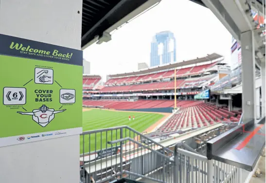  ?? Aaron Doster, The Associated Press ?? A view of a sign promoting social distancing for fans during a workout in Cincinnati on Wednesday. The Cardinals play in an opening day game at the Cincinnati Reds on Thursday.