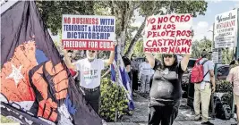  ?? PEDRO PORTAL pportal@miamiheral­d.com ?? Agustin Acosta, left, and Catalina Vazquez were among dozens of Cubans who protested at Versailles Restaurant against the presence in Miami of the Cuban national baseball team for Sunday’s World Baseball Classic semifinal game.