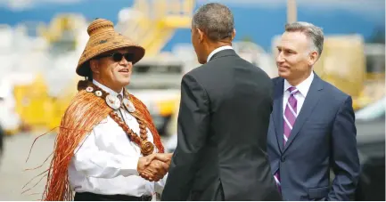  ?? (Kevin Lamarque/Reuters) ?? US PRESIDENT Barack Obama shakes hands with National Congress of American Indians President Brian Cladoosby upon landing in Seattle earlier this year. At right is King County Executive Dow Constantin­e.