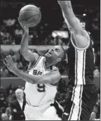  ??  ?? SPUR OF THE MOMENT: San Antonio Spurs’ Tony Parker ( 9) is defended by Utah Jazz’s Enes Kanter, right, during the fourth quarter of Game 1 of a first- round NBA playoff series, Sunday in San Antonio. San Antonio won 106- 91.