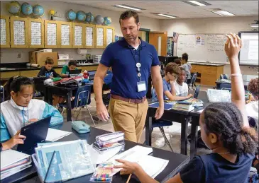  ?? PHOTOS BY STEVE SCHAEFER / FOR THE AJC ?? Samuel M. Inman Middle School earth science teacher Spence Ford has taught for 17 years in five districts in Georgia and South Carolina, exposing him to varied tactics and attitudes on teaching climate change.