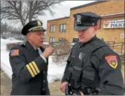  ?? NICHOLAS BUONANNO — NBUONANNO@TROYRECORD.COM ?? Outgoing North Greenbush Police Chief Robert Durivage uses a radio from a North Greenbush police officer Friday afternoon to make his out of service radio call.