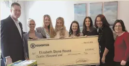  ?? PHOTO COURTESY OF BOSTON BRUINS ?? Bruins wives and Boston Bruins Foundation Executive Director Bob Sweeney, left, present big money — a $12,000 donation — to staff at the Elizabeth Stone House in Roxbury.