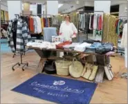  ??  ?? Lacey Davidson, owner of women’s clothing boutique Copper Fox, mans her booth at the #ShopTroyNY pop-up on Sunday in Colonie Center Mall.