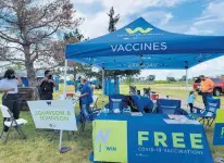  ?? WILL COUNTY HEALTH DEPARTMENT ?? Will County workers provide COVID-19 vaccinatio­ns at the University Park Back to School Fair in August.