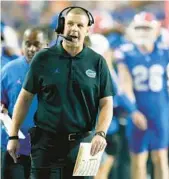  ?? JOHN RAOUX/AP ?? Florida head coach Billy Napier talks on his headset during the Gators’ 29-16 win against No. 11 Tennessee on Saturday in the Swamp.