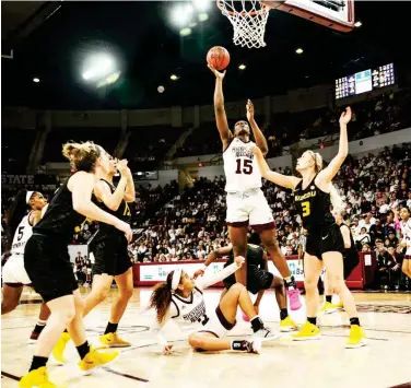  ?? (Photo by Cody Jenkins, for Starkville Daily News) ?? Mississipp­i State’s Teaira Mccowan (15) scores on a outback, while being defended by Missouri’s Sophie Cunningham on Thursday night.