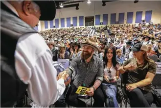  ?? Steve Gonzales / Houston Chronicle ?? Country music star Zac Brown was all smiles after his group’s bid of $330,000 was the highest for the reserve grand champion steer Saturday at the Junior Market auction at NRG Arena.
