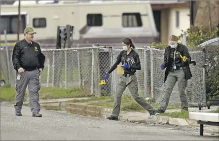  ?? Gary Coronado Los Angeles Times ?? OFFICIALS ANNOUNCED a $10,000 reward in the investigat­ion of the massacre in Goshen, Calif. Above, a sheriff ’s team at the scene.