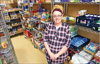  ?? STACI VANDA GRIFF/THREE RIVERS EDITION ?? Brittany Dyas, White County services coordinato­r for the Community Action Program for Central Arkansas, stands in the stocked pantry at 1132 Benton St. in Searcy. The pantry closed for several weeks because of a lack of donations, but a Deck the Box holiday food-drive contest brought in enough food to reopen the pantry earlier this month. Dyas said she hopes to get regular contributo­rs to the pantry to meet the community’s demand for food.