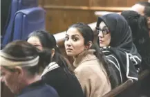  ?? STAFF PHOTO BY TIM BARBER ?? In Judge Tom Greenholtz’s courtroom Tuesday, Sara Baluch, the fiancée of Mohammad Sharifi, sits with family members while a trial date was set for D’Marcus White, who is charged in the death of Sharifi.