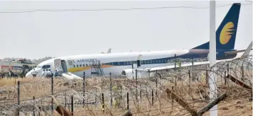  ?? AFP ?? Indian officials gather beside a Jet Airways Boeing 737 aircraft after it skidded off the runway following an aborted take-off at the Goa Airport in Dabolim, in Goa on Tuesday. —