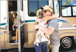  ?? NOAH BERGER AP ?? Woody Faircloth hugs Sheri Roen as her family donates their motorhome to Emergencyr­v.org. Faircloth delivered it to a Dixie fire victim later that day.