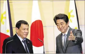  ?? EUGENE HOSHIKO / ASSOCIATED PRESS ?? Philippine President Rodrigo Duterte (left) and Japanese Prime Minister Shinzo Abe prepare to exit a joint news conference Wednesday after their meeting at Abe’s official residence in Tokyo.