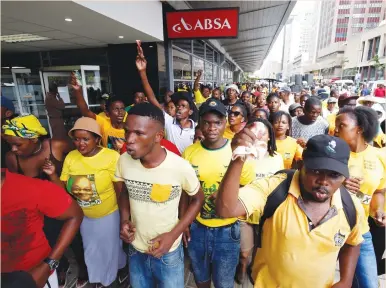  ?? (Rogan Ward/Reuters) ?? MEMBERS OF the African National Congress Youth League protest in front of an ABSA Bank branch against what they say is the bank benefiting from an apartheid-era bailout yesterday in Durban, South Africa.