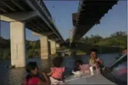  ?? RODRIGO ABD — THE ASSOCIATED PRESS ?? A family picnics on the banks of the Rio Grande in Miguel Aleman, Tamaulipas state, Mexico, located across the river from Roma, Texas.