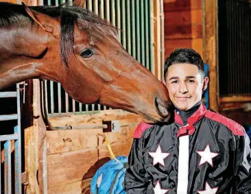  ?? [PHOTO BY JIM BECKEL, THE OKLAHOMAN] ?? Remington Park jockey David Cabrera poses for a photo with Tone Broke, the horse he will be riding Sunday night in the Springboar­d Mile.